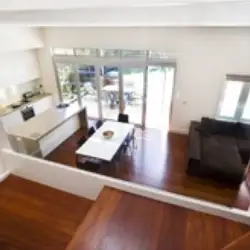 Living area viewed through glass panel on stairwell